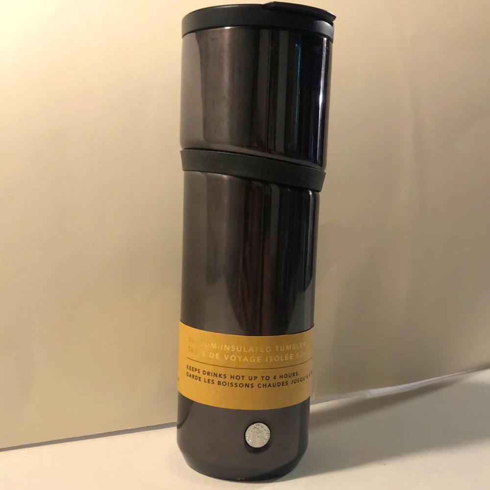 Vintage 2018 Starbucks reusable coffee tumbler with silicone band; black.